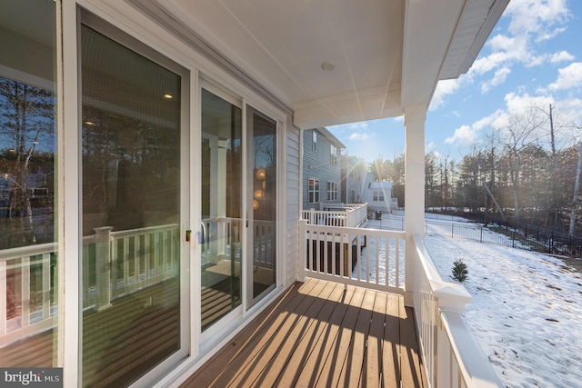 view of snow covered back of property