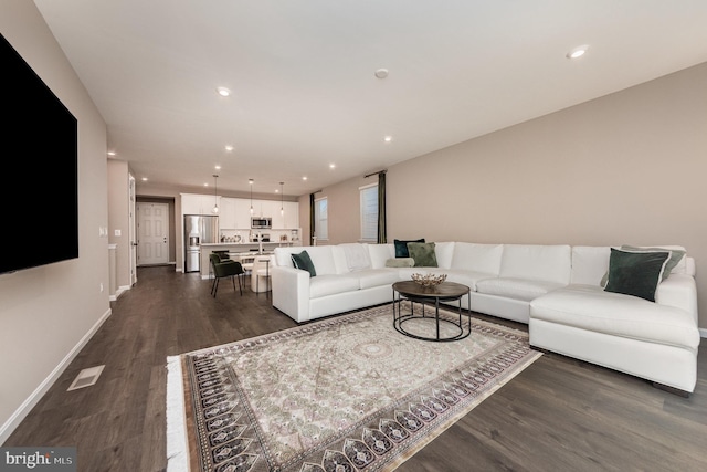 living room featuring dark wood-type flooring