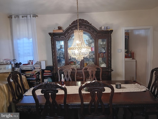 dining area featuring a notable chandelier