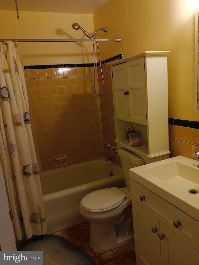 full bathroom featuring toilet, vanity, and shower / bath combination with curtain