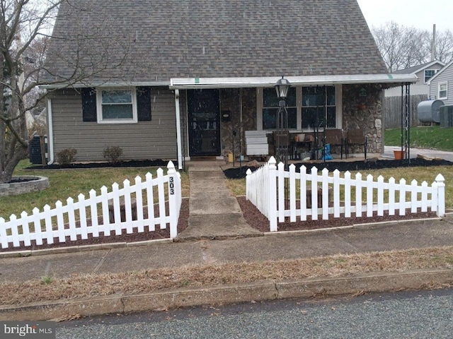 view of front of house with covered porch and central AC