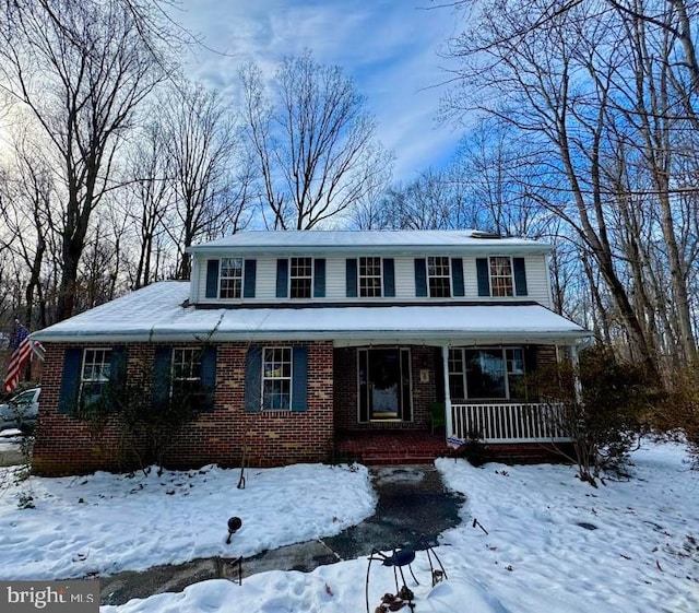 view of front of house with covered porch and brick siding