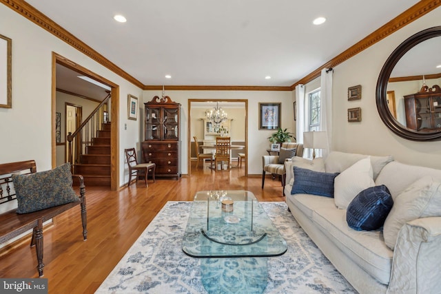 living area with ornamental molding, stairway, wood finished floors, and recessed lighting