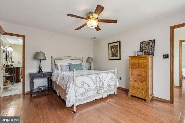 bedroom with a ceiling fan, wood finished floors, visible vents, and baseboards