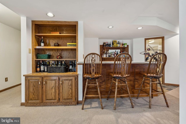 bar featuring recessed lighting, baseboards, carpet flooring, and a bar