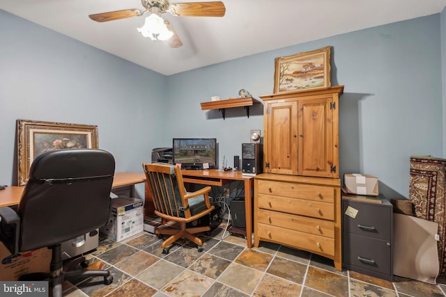 office with stone tile floors and ceiling fan