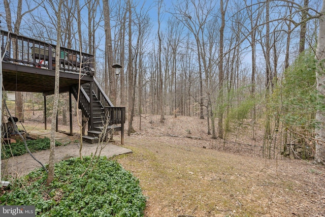 view of yard with a wooden deck and stairs