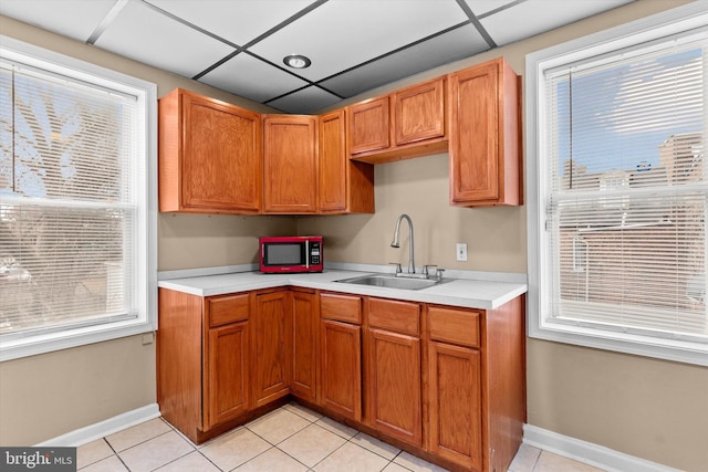 kitchen with sink, a wealth of natural light, and light tile patterned flooring