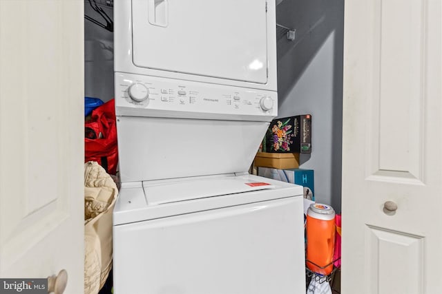 laundry room with stacked washer and clothes dryer