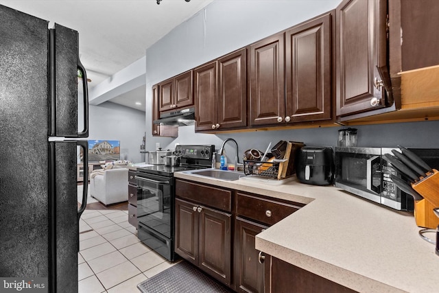 kitchen with dark brown cabinetry, sink, black appliances, and light tile patterned flooring