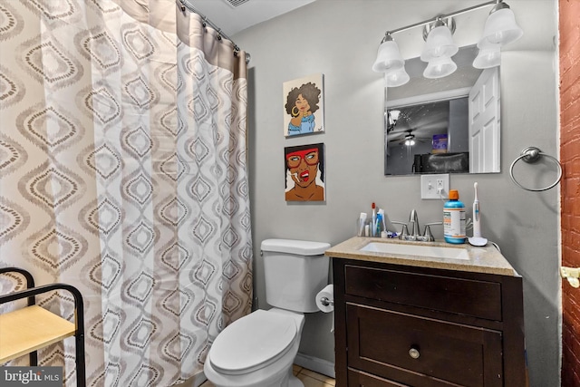 bathroom featuring vanity, a shower with shower curtain, and toilet