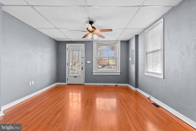 spare room with wood-type flooring, a paneled ceiling, and ceiling fan