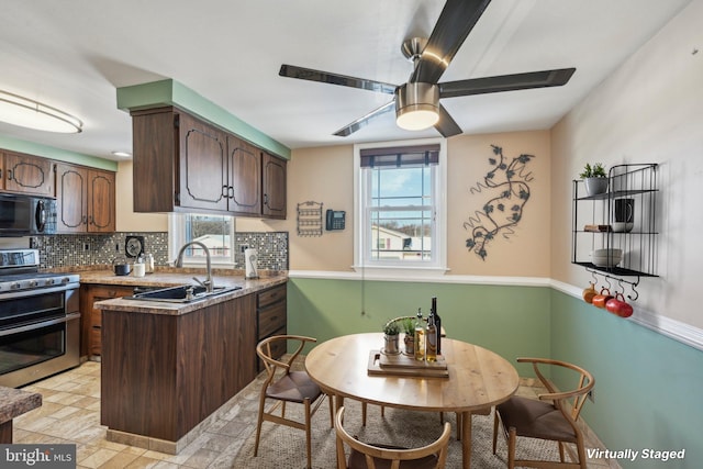 kitchen featuring sink, dark brown cabinets, double oven range, kitchen peninsula, and backsplash