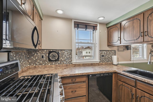 kitchen with sink, stainless steel gas range oven, dishwasher, and plenty of natural light