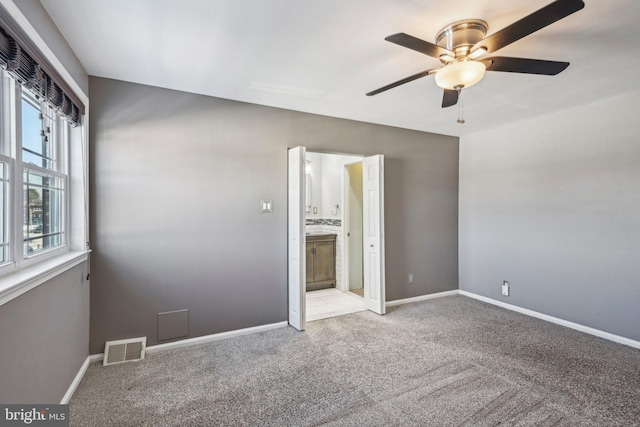 interior space featuring light colored carpet and ceiling fan