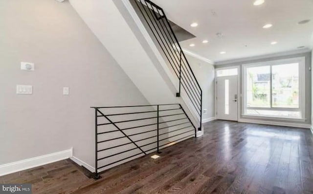 foyer entrance featuring dark hardwood / wood-style floors and ornamental molding