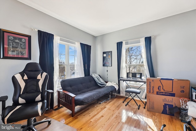 home office with a wealth of natural light and light hardwood / wood-style flooring