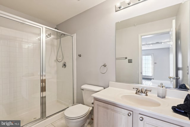 bathroom with tile patterned flooring, toilet, walk in shower, and vanity