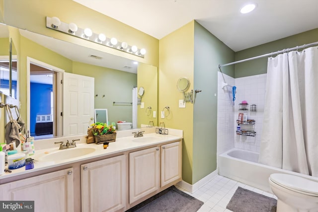 full bathroom with toilet, vanity, tile patterned flooring, and shower / bath combo with shower curtain