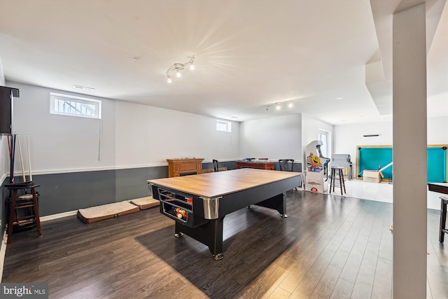 recreation room with hardwood / wood-style flooring and track lighting