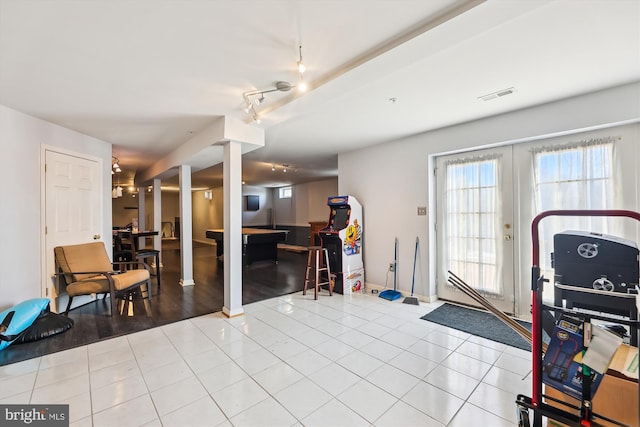 interior space featuring light tile patterned floors, french doors, and track lighting