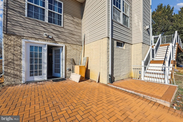 view of exterior entry featuring a patio area