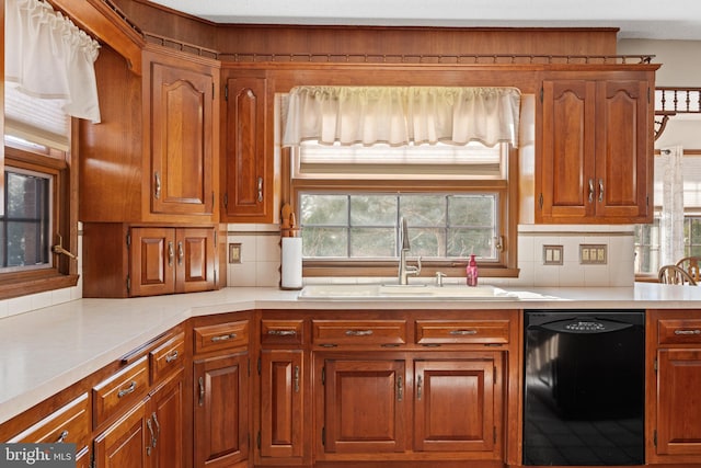 kitchen featuring black dishwasher, backsplash, and sink