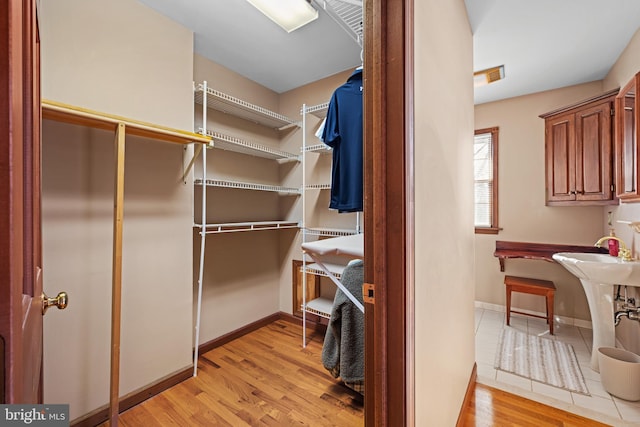 spacious closet featuring light wood-type flooring