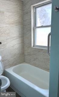 bathroom with toilet and shower / bath combination