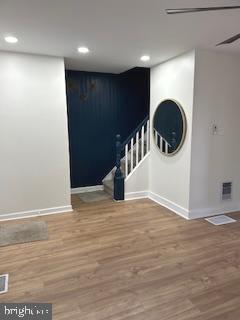 interior space featuring hardwood / wood-style flooring and ceiling fan