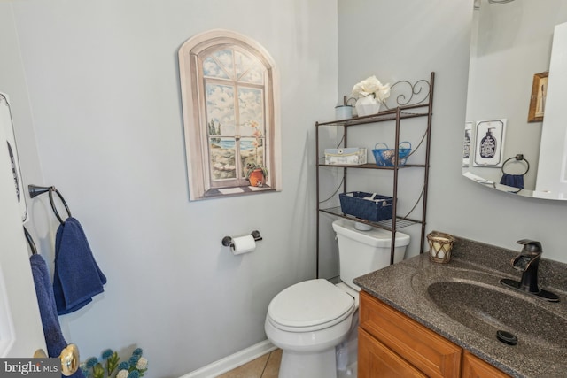 bathroom featuring toilet, vanity, and tile patterned floors