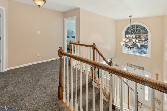 corridor featuring carpet and a notable chandelier