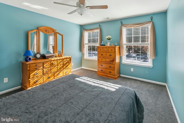 unfurnished bedroom featuring ceiling fan and dark carpet