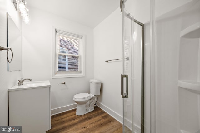 bathroom featuring vanity, toilet, an enclosed shower, and wood-type flooring