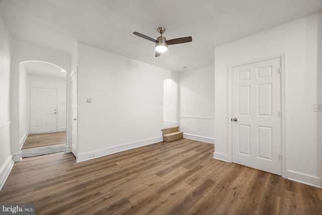 empty room with ceiling fan and wood-type flooring