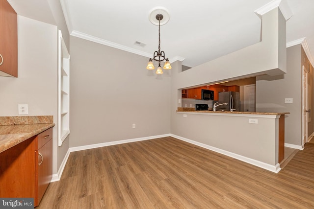 kitchen with pendant lighting, stainless steel fridge, built in features, and ornamental molding