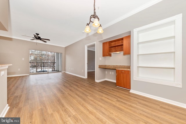 unfurnished living room featuring ceiling fan with notable chandelier, built in desk, built in shelves, light hardwood / wood-style floors, and crown molding