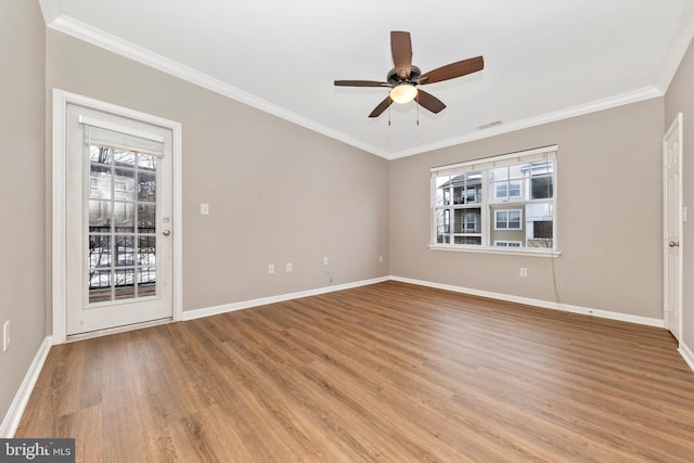 spare room with ceiling fan, crown molding, and light wood-type flooring