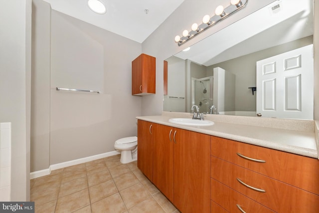 bathroom featuring toilet, tile patterned flooring, an enclosed shower, and vanity