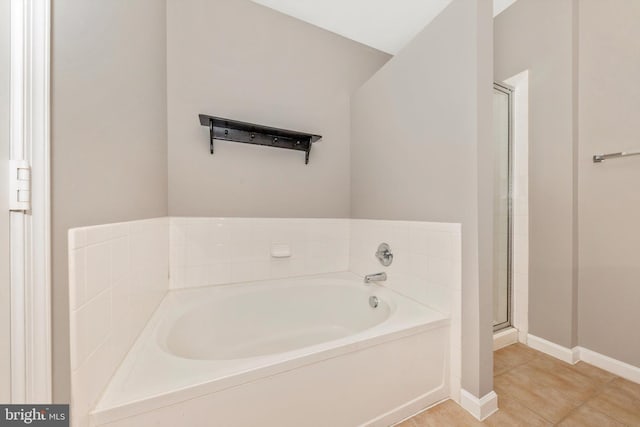 bathroom with separate shower and tub and tile patterned flooring