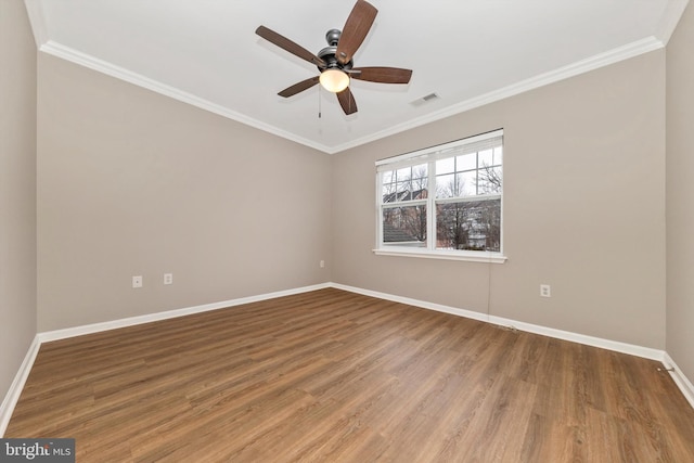 empty room with wood-type flooring and ornamental molding