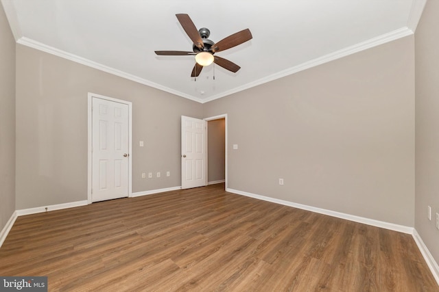 empty room with ceiling fan, hardwood / wood-style floors, and ornamental molding