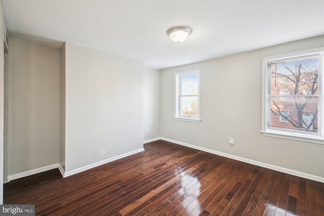 spare room featuring dark hardwood / wood-style floors