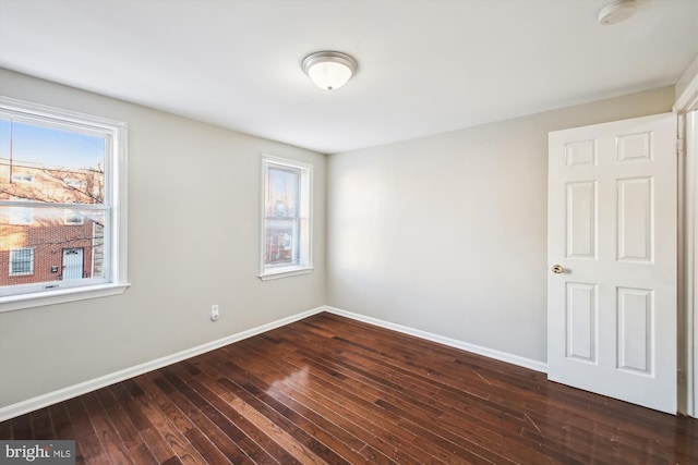 spare room featuring dark wood-type flooring