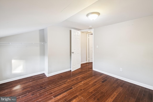 unfurnished bedroom featuring dark wood-type flooring and a closet