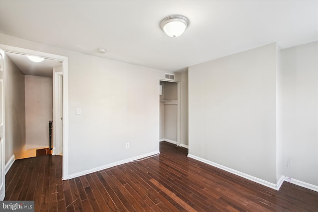 unfurnished room featuring dark wood-type flooring