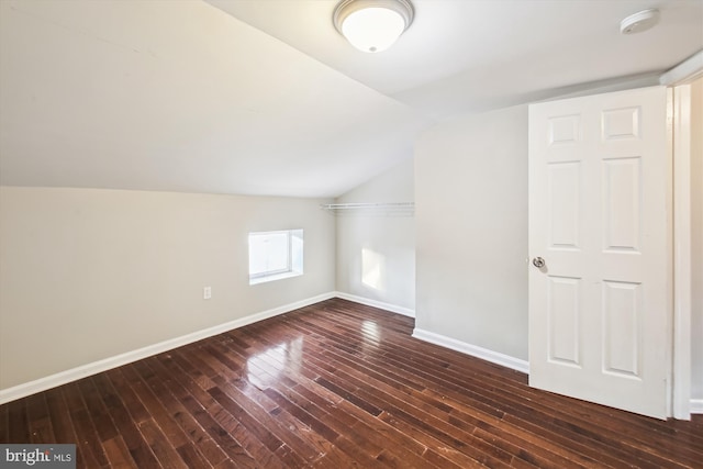 additional living space featuring dark hardwood / wood-style floors and vaulted ceiling