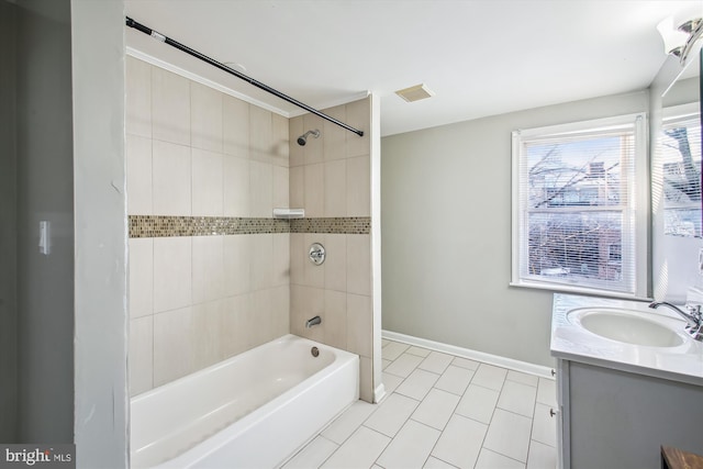 bathroom featuring vanity, tile patterned flooring, and tiled shower / bath combo