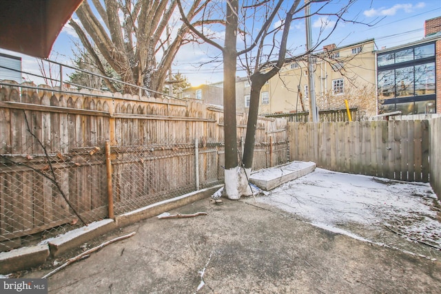 snowy yard with a patio area