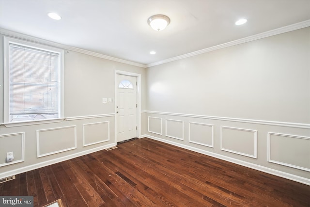 interior space featuring ornamental molding, dark hardwood / wood-style floors, and plenty of natural light